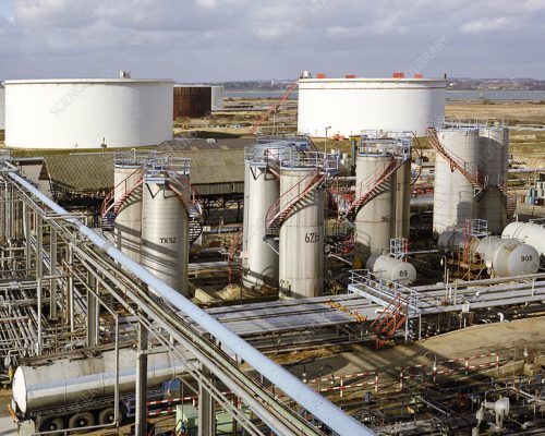 ^BChemical plant storage tanks.^b The industrial-scale manufacture of chemicals requires specialised engineering to meet a wide range of storage requirements. Products and reactants, ranging from liquids to gases and solids, have to be kept at the correct temperature and pressure. They then need to be piped or transported around the site to and from these storage facilities. These tanks are part of a larger oil refinery and chemical manufacturing site. Oil refining and chemical manufacturing are closely related industries, as oil products are used in a wide range of chemical industry manufacturing processes. Photographed at ExxonMobil's Fawley Oil Refinery and Chemical Plant, Hampshire, UK, which is one of the largest petrochemical plants in Europe.